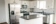 White kitchen with subway tile backsplash and black laminate countertops