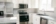 White Kitchen with Light Laminate Countertops and Grey Subway Tile Backsplash
